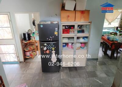 Kitchen with refrigerator and storage units