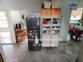 Kitchen with refrigerator and storage units