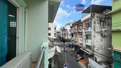 View from balcony showing urban street and buildings