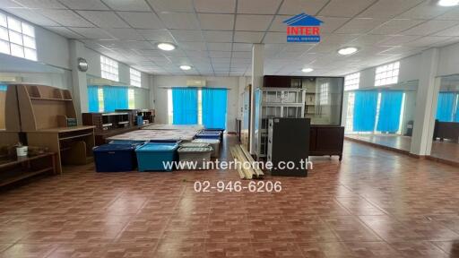 Spacious room with tiled floor and multiple storage units