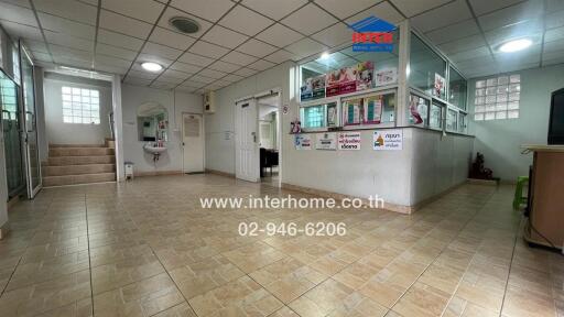 Office reception area with tiled floors and informational banners