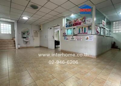 Spacious lobby area with tiled flooring and information desks