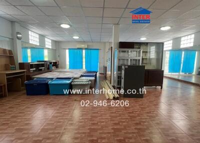 Spacious room with large windows and tiled floor