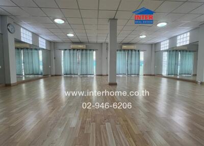 Spacious room with wooden flooring and large windows