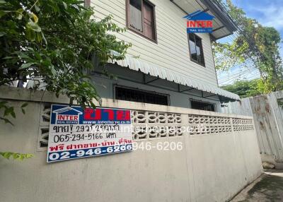 Exterior view of two-story house with signage