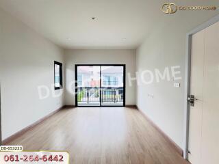 Spacious living room with large windows and wooden floors