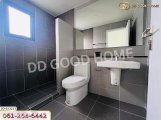 Modern bathroom with grey tiles and a large mirror