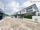 Street view of modern residential houses with green hedges