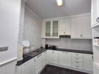 Modern white kitchen with ample cabinetry and countertop space