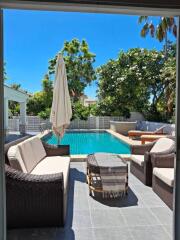 Patio overlooking swimming pool with outdoor furniture