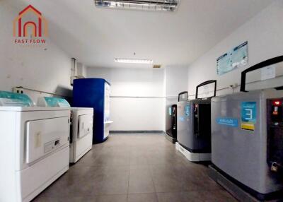 Clean and spacious laundry room with modern machines