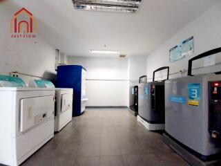 Clean and spacious laundry room with modern machines