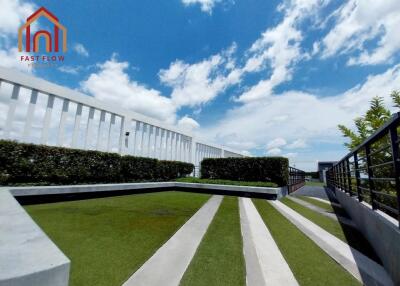 Modern outdoor area with greenery and clear blue sky