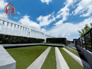 Modern outdoor area with greenery and clear blue sky