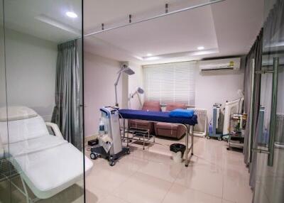 Modern clinic room with medical equipment and furniture