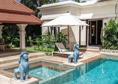 Luxurious outdoor pool area with statues and sun loungers