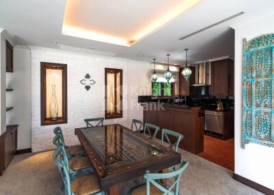 Well-lit dining area with a large table, chairs, and modern light fixtures