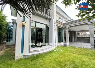 Modern residential building exterior with green lawn