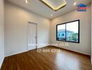 Spacious bedroom with wooden floor and large window