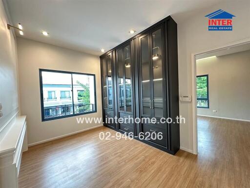 Spacious bedroom with large windows and built-in wardrobe