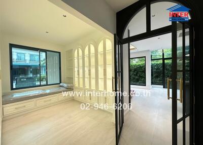 Bright living area with large windows and built-in shelving