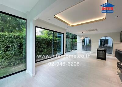 Bright and spacious main living area with large windows and garden view