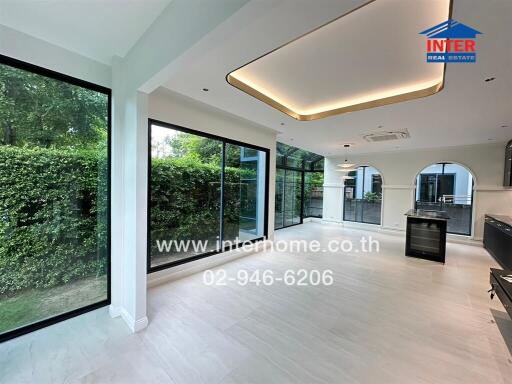 Bright and spacious main living area with large windows and garden view