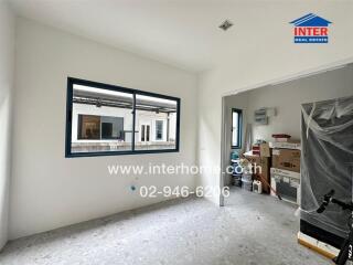 Unfurnished room with window and boxes