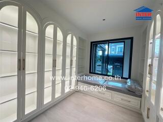 Bright living space with built-in shelving and large windows