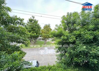 View from the property showing a greenery-filled neighborhood with trees and a nearby park