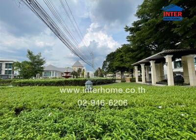 View of residential buildings with green garden