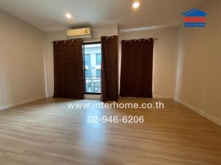 Spacious living room with wooden floor and large window