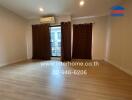 Spacious living room with wooden floor and large window