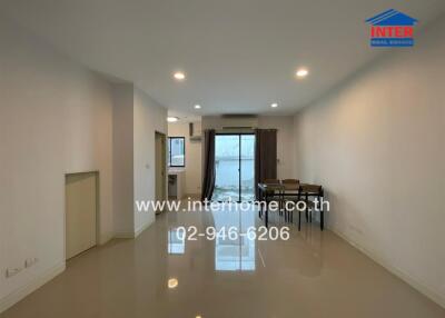 Spacious living and dining area with large windows and ample lighting