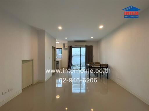 Spacious living and dining area with large windows and ample lighting