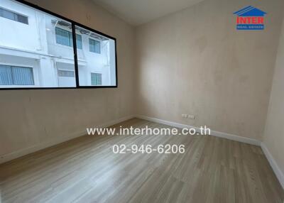 empty bedroom with large windows and wooden floor