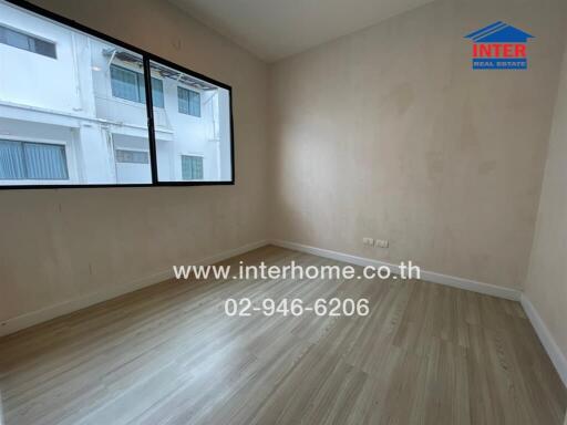 empty bedroom with large windows and wooden floor