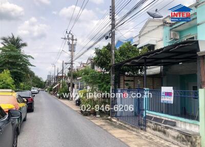 Street view of neighborhood with houses and cars