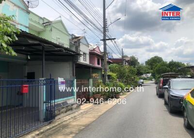 Street view of residential area with houses and parked cars