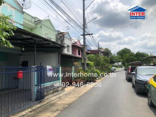 Street view of residential area with houses and parked cars