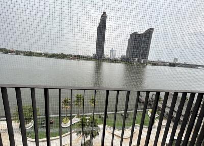 Balcony with river view and distant modern buildings