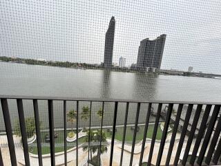 Balcony with river view and distant modern buildings