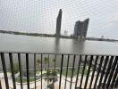 Balcony with river view and distant modern buildings