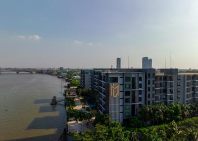 View of a riverside apartment building with surrounding urban landscape