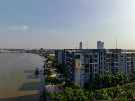 View of a riverside apartment building with surrounding urban landscape