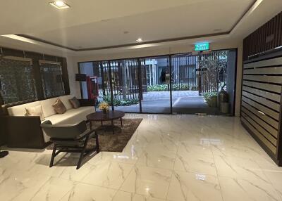 Modern lobby with seating area and mailboxes