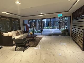 Modern lobby with seating area and mailboxes