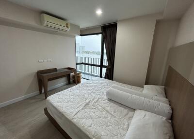 Bedroom with large window and city view