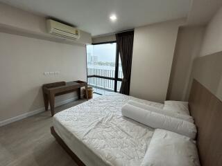 Bedroom with large window and city view