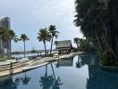 Outdoor area with a swimming pool, palm trees, and a shaded structure